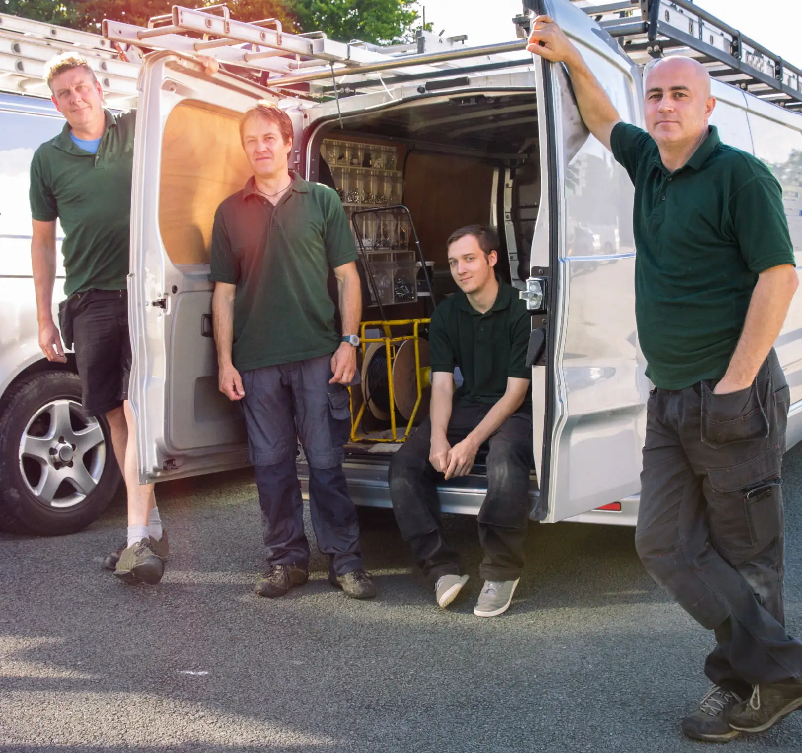 Construction team with van and equipment showing van tracking benefits